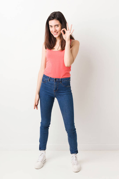 Full body young woman on white background cheerful and confident showing ok gesture. - Φωτογραφία, εικόνα