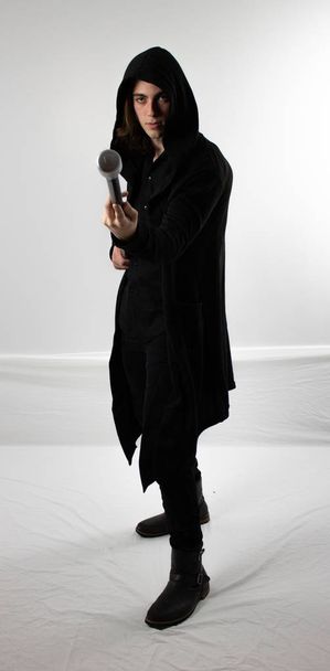 Σκοτεινός πολεμιστής κυνηγός με μαύρη κουκούλα με το προσωπικό - Φωτογραφία, εικόνα