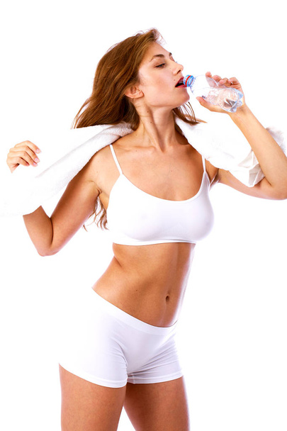 Fitness diet, Young beautiful blonde girl drinking water from a  - Fotó, kép