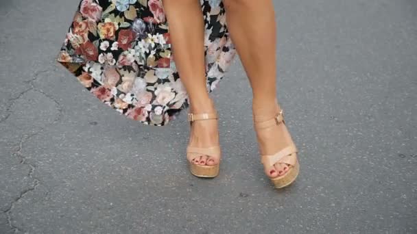 Legs of a woman in shoes walking along the road - Felvétel, videó