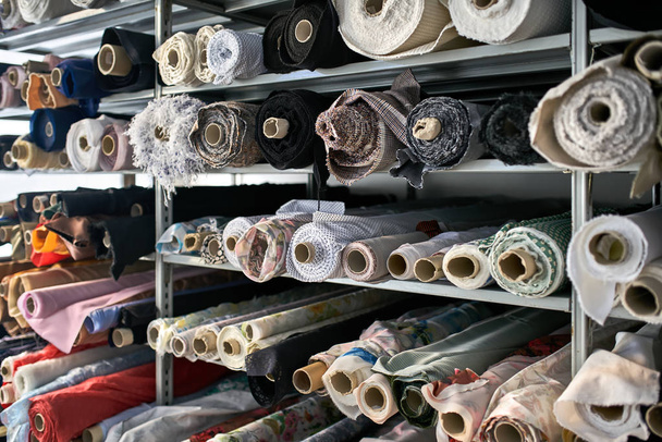 Fabric warehouse with many multicolored textile rolls - Zdjęcie, obraz