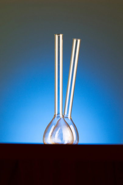 Glass retorts against blue gradient - Zdjęcie, obraz
