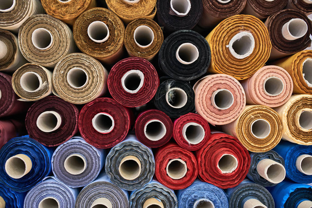 Fabric warehouse with many multicolored textile rolls - Фото, зображення
