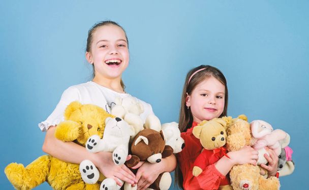 Kids adorable cute girls play soft toys. Happy childhood. Child care. Sisters best friends play. Sweet childhood. Childhood concept. Softness and tenderness. Laundry softener. Love and friendship - Fotoğraf, Görsel