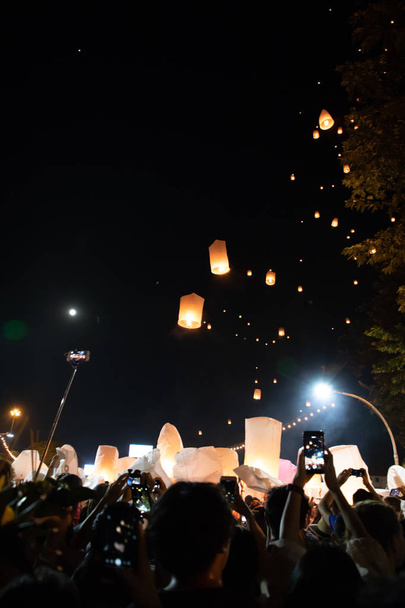 People releasing paper lanterns during Loi Krathong and Yi Peng festival - Photo, Image