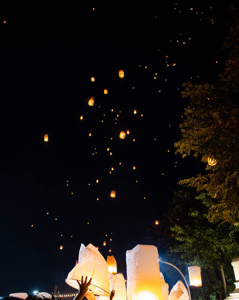 People releasing paper lanterns during Loi Krathong and Yi Peng  - Photo, Image