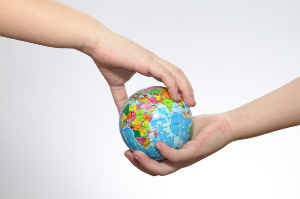 The globe in hands of the child. - Photo, Image
