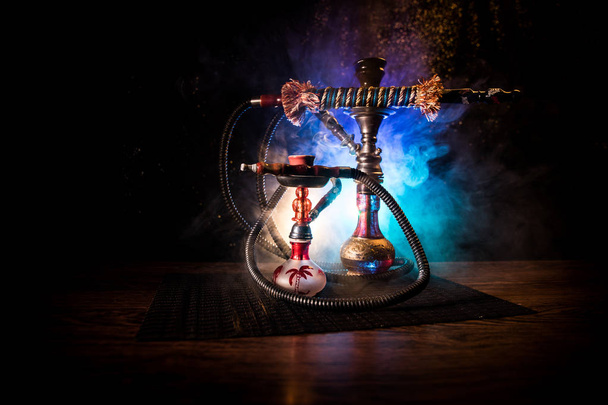 Hookah hot coals on shisha bowl on dark foggy background. Stylish oriental shisha. - Фото, изображение