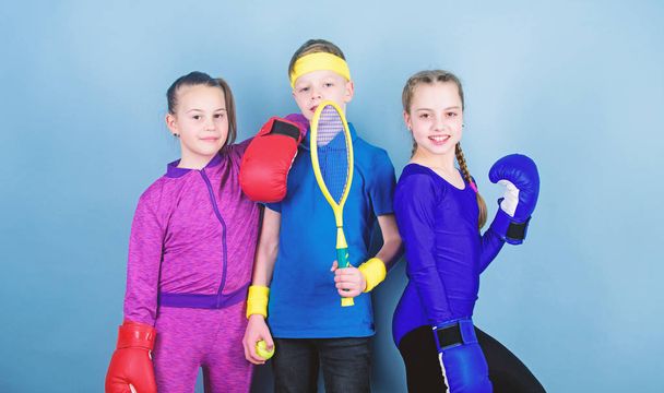 Born to fight. Happy children in boxing gloves with tennis racket and ball. Fitness energy health. punching knockout. Team sport success. workout of small girls boxer and boy in sportswear - Φωτογραφία, εικόνα