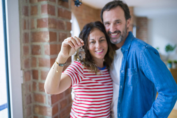 Middle age senior romantic couple holding and showing house keys - Photo, Image