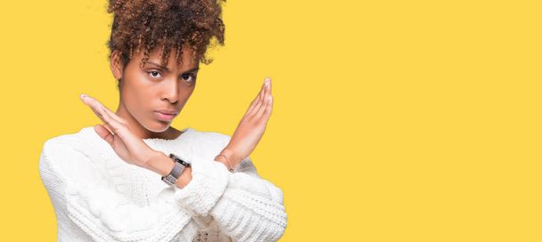 Beautiful young african american woman wearing winter sweater over isolated background Rejection expression crossing arms doing negative sign, angry face - Фото, зображення