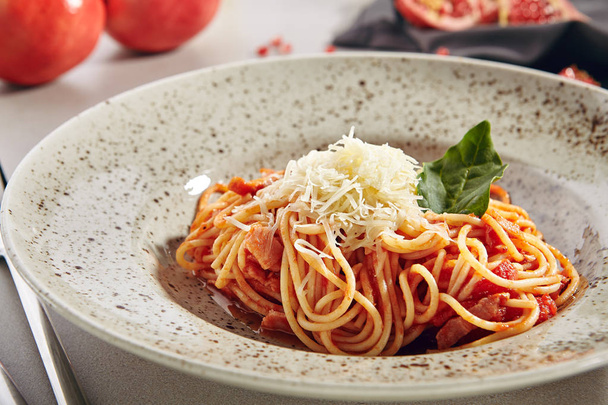 Italian Spaghetti with Amatriciana Sauce and Grated Cheese - 写真・画像