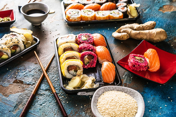 close-up view of sushi set on slate boards with chopsticks - Foto, Imagem