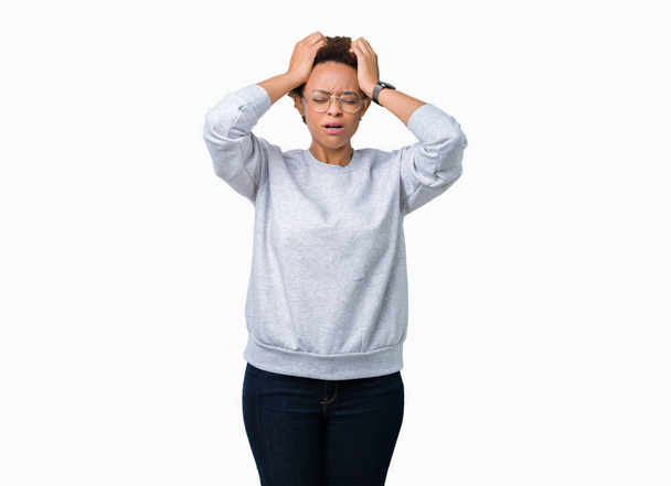 Young beautiful african american woman wearing glasses over isolated background suffering from headache desperate and stressed because pain and migraine. Hands on head. - Fotografie, Obrázek