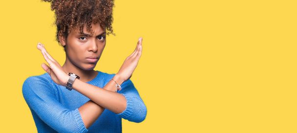 負の符号、怒った顔をして孤立した背景除去式交差腕の上の美しい若いアフリカ系アメリカ人女性 - 写真・画像