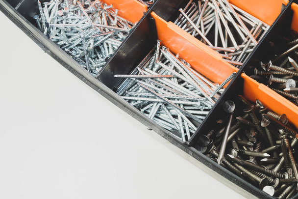 Various metal nails in toolbox background. nails in the cells of the box - Φωτογραφία, εικόνα