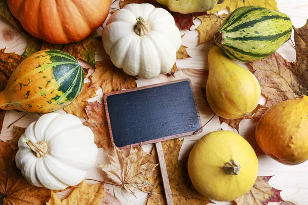 Blank blackboard label, pumpkins and leaves - Photo, Image