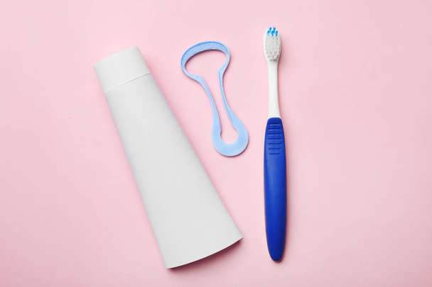 Tongue cleaner, tooth paste and brush on color background, flat lay - Foto, immagini