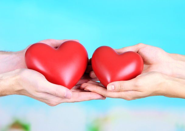Hearts in hands on cloud background - Photo, image