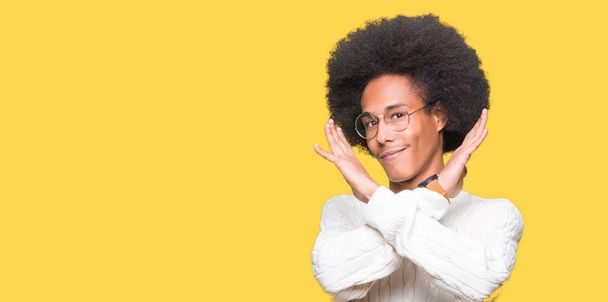 Young african american man with afro hair wearing glasses Rejection expression crossing arms doing negative sign, angry face - Fotografie, Obrázek
