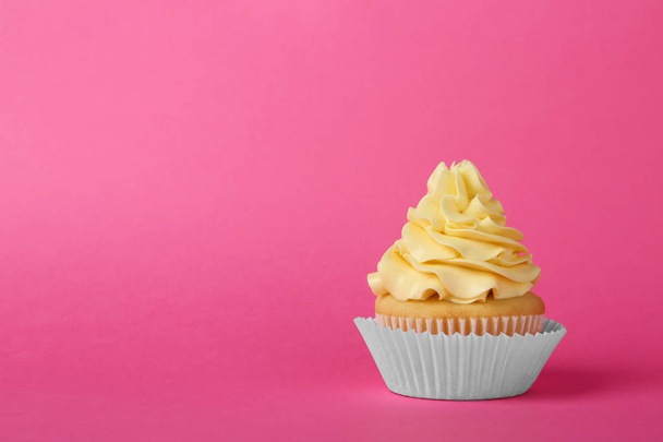 Tasty cupcake with cream on pink background, space for text - Фото, зображення