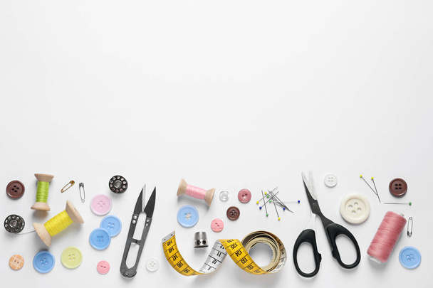 Flat lay composition with scissors and sewing supplies on white background. Space for text - Фото, зображення