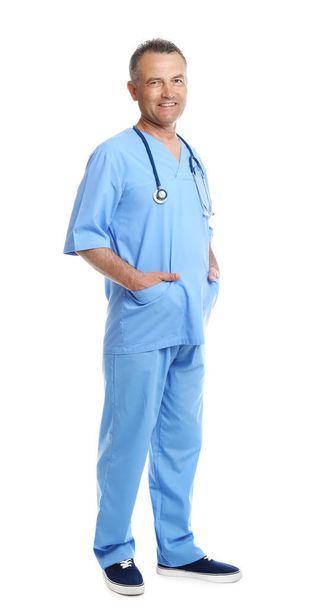 Full length portrait of experienced doctor in uniform on white background. Medical service - Valokuva, kuva