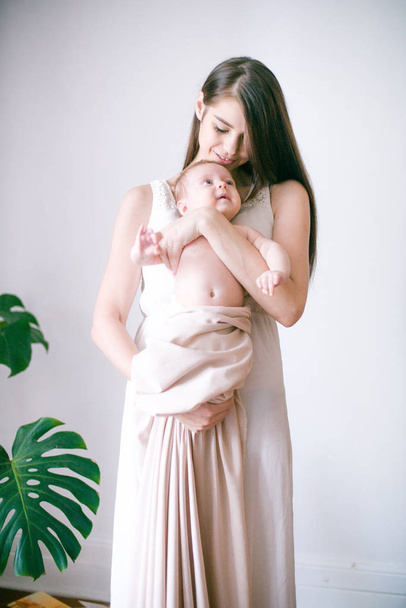 family, child and parenthood concept - happy smiling young mother with little baby at home - 写真・画像