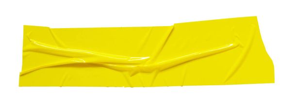 Yellow sticky scotch tape. Torn crumpled sellotape piece isolated on white background - Photo, Image