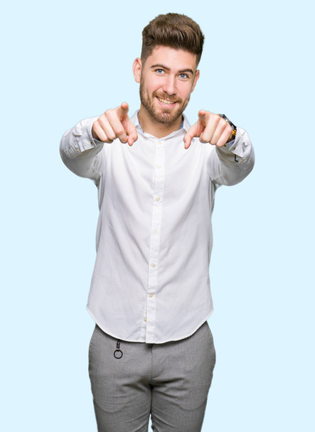 Young handsome business man Pointing to you and the camera with fingers, smiling positive and cheerful - Photo, Image
