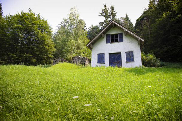 white cabin in green meadow - Photo, Image