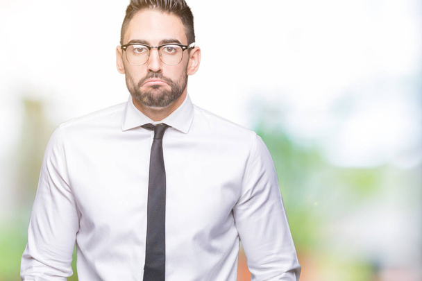 Young handsome business man wearing glasses over isolated background depressed and worry for distress, crying angry and afraid. Sad expression. - Photo, Image