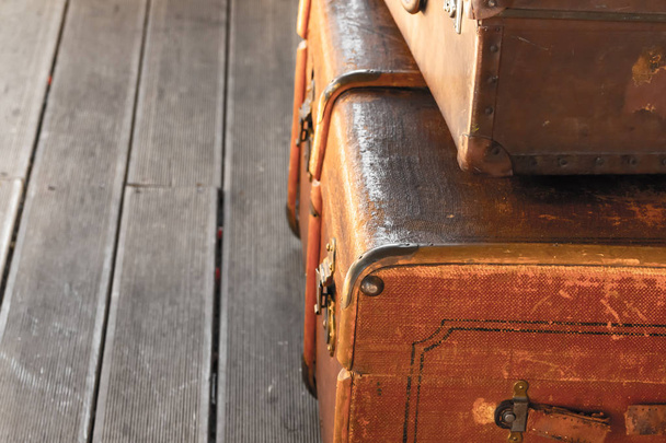 stack old weathered brown suitcase pair luggage copy space brown wooden floor train station - Photo, Image