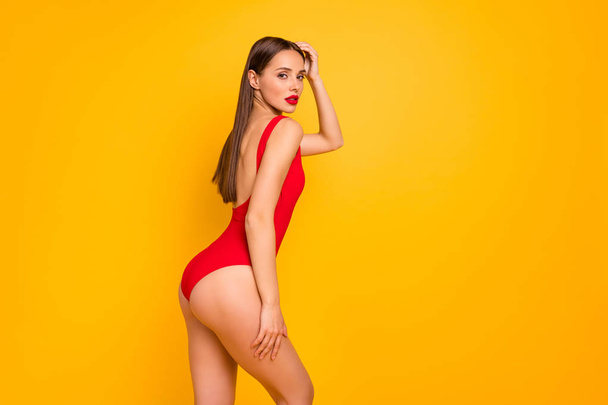 Profile side view portrait of nice-looking attractive glamorous lovely lovable fascinating sportive straight-haired lady perfect figure shape form line isolated on bright vivid shine yellow background - Foto, Imagen