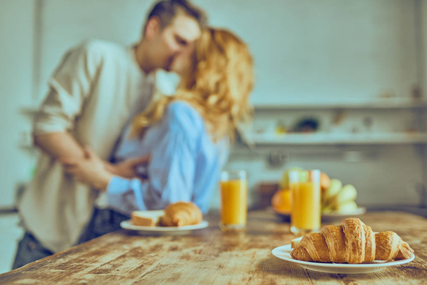 Romantic young couple cooking together in the kitchen, having a great time together.  - Fotoğraf, Görsel