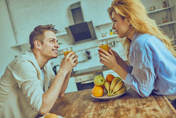 Romantic young couple cooking together in the kitchen, having a great time together.  - Foto, immagini