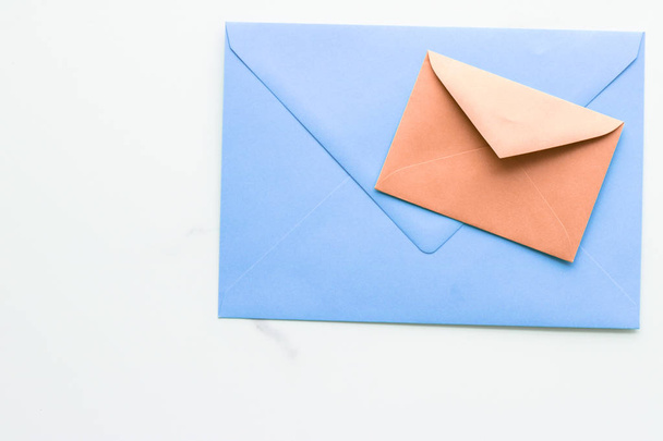 Blank paper envelopes on marble flatlay background, holiday mail - 写真・画像