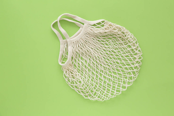 Reusable shopping bag on color background. Ecological concept. Top view of mesh shopping cotton bag. Caring for the environment and the rejection of plastic.  - Fotoğraf, Görsel