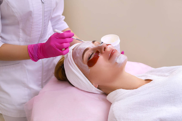Spa Woman applying Facial cleansing Mask. - Fotó, kép