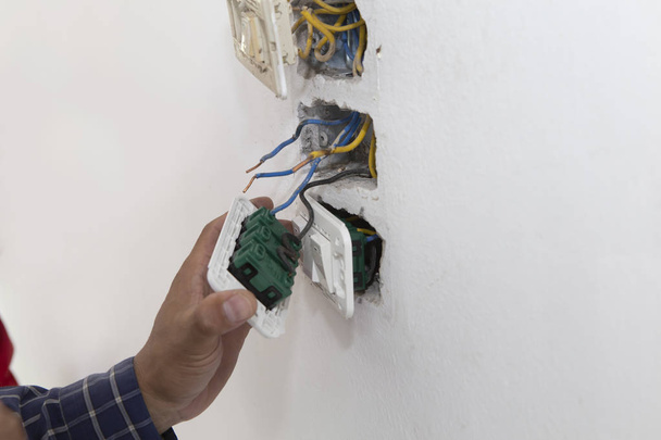 Electrician working at plug socket. Repair concept. - Photo, Image