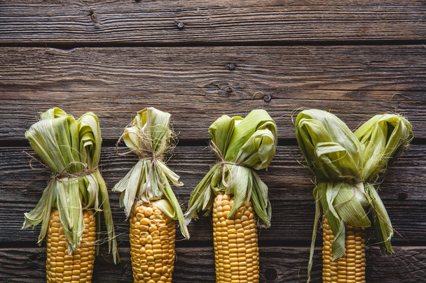fresh corn on wooden table - Fotó, kép