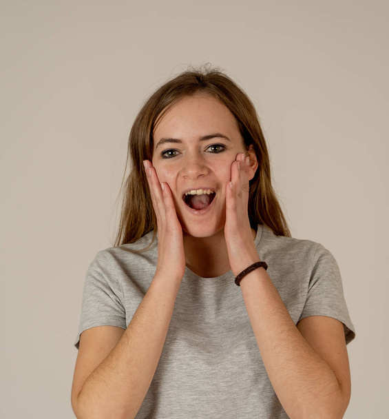 Portrait of beautiful shocked and shy teenager female having great success with surprised and happy face and gestures in Facial Expression, Human Emotions and celebration. Isolated on white. - Φωτογραφία, εικόνα