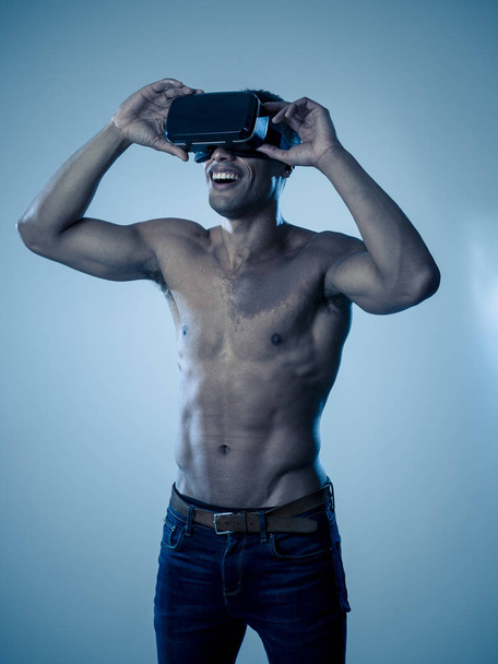 Attractive african american man using augmented VR glasses exploring 3d world feeling excited about simulation, new sensations and desires. In virtual reality, innovation and new technology concept. - Zdjęcie, obraz