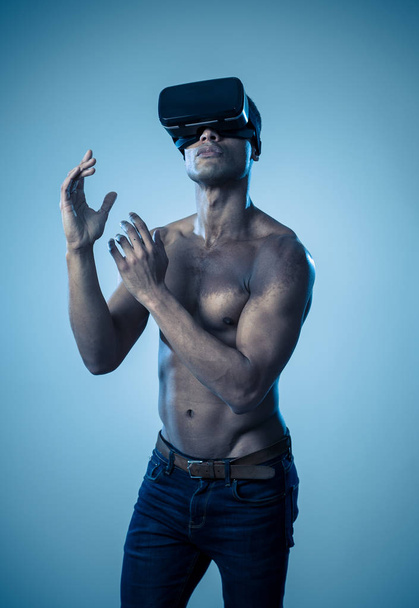 Attractive african american man using augmented VR glasses exploring 3d world feeling excited about simulation, new sensations and desires. In virtual reality, innovation and new technology concept. - Photo, Image