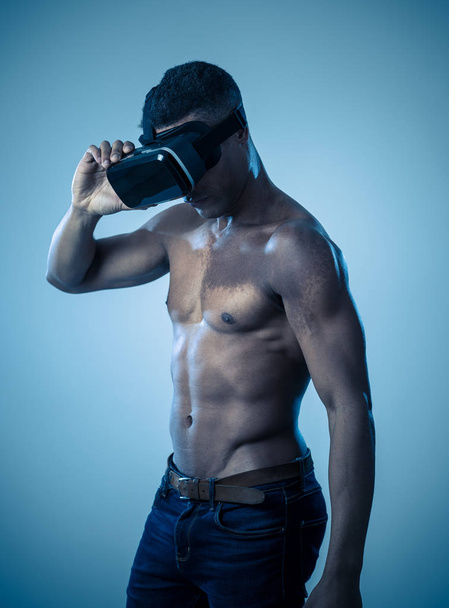 Attractive african american man using augmented VR glasses exploring 3d world feeling excited about simulation, new sensations and desires. In virtual reality, innovation and new technology concept. - Foto, afbeelding