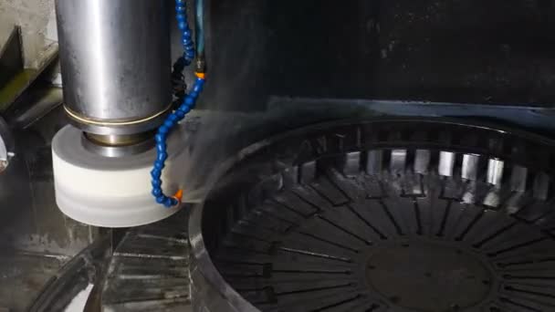 Part of fully automatical bearing assembling. Industry concept. Grinding wheel disk polishing metal surface on bearings manufacture. Rolling mill machine with cooling water splashing. close up. 4k - Footage, Video