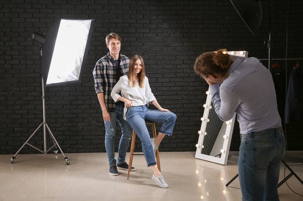 Professional photographer working with models in studio - Photo, Image