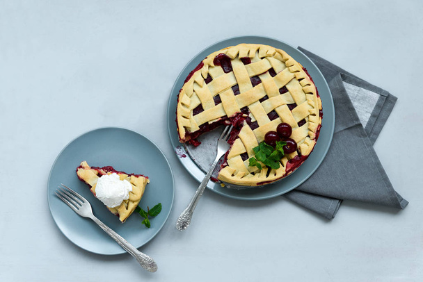 Homemade cherry lattice cake on gray wooden background. Traditional american food. Top view - 写真・画像