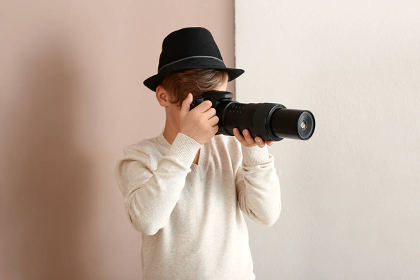 Cute little photographer with professional camera indoors - Foto, Imagem