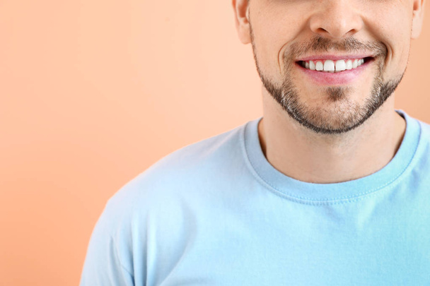Man with healthy teeth on color background - Photo, Image